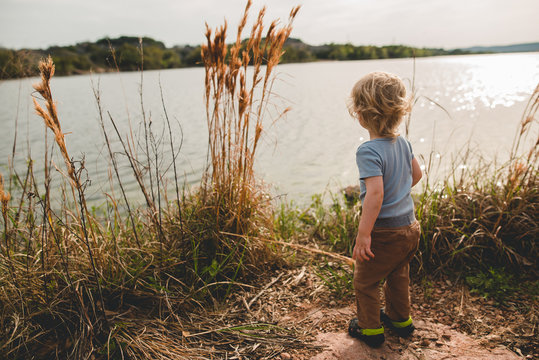 Boy throwing rocks into water