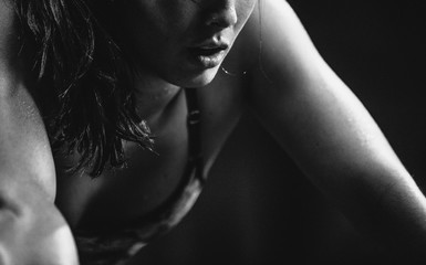 Active, fit mixed race woman exhausted after intense workout at gym