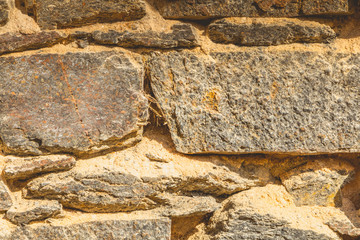 old stone wall with dry torchi which is crumbling