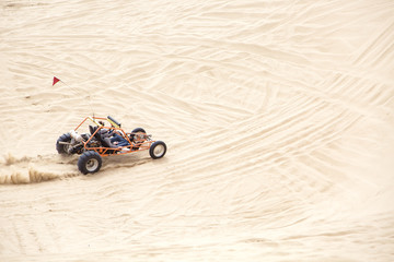 Friends driving a sand rail