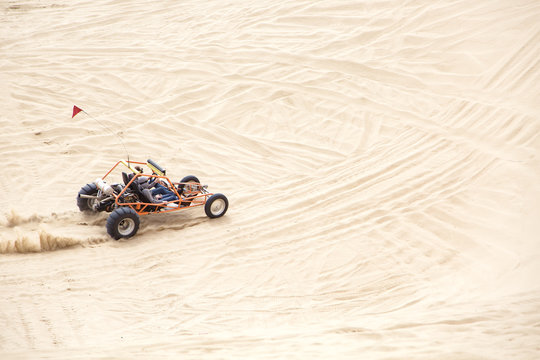 Friends driving a sand rail