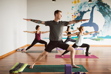 Group of young adults in yoga class