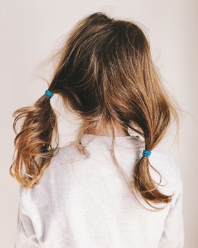 little girls's messy hair at the end of the day