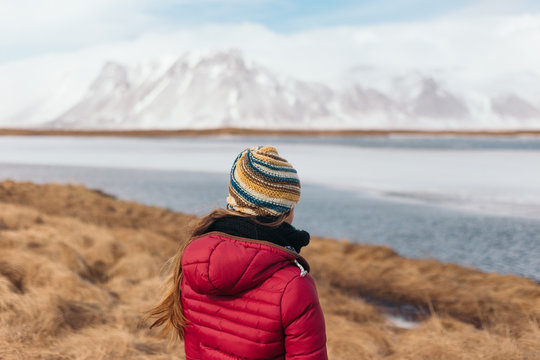 Anonymous explorer facing a lake