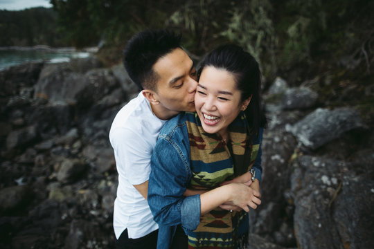 Young happy asian couple spending quality time together outside in nature