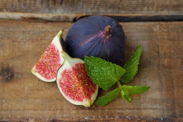 Delicious fresh figs with mint on the table  