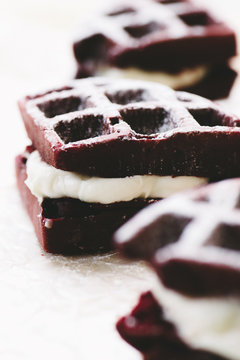 Red Velvet Cake Waffles Sandwiches On Parchement Paper