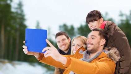 friends with tablet pc taking selfie in winter