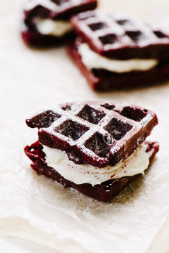 Red Velvet Cake Waffles Sandwiches On Parchement Paper