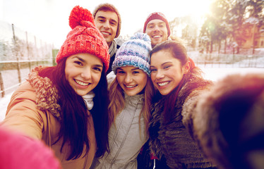 happy friends taking selfie with smartphone