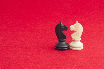 White horse and black horse, traditionally confronted in chess game, have reconciled. Image in...