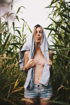 Young blonde girl showing tongue