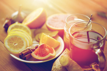 ginger tea with honey, citrus and garlic on wood