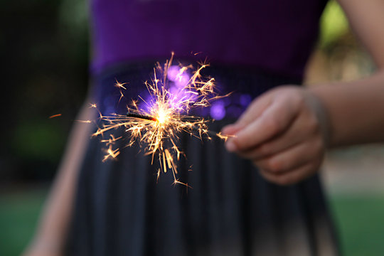 Young girl holding a sparkler