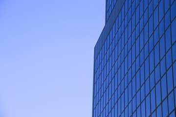 Office building with glass windows and blue sky