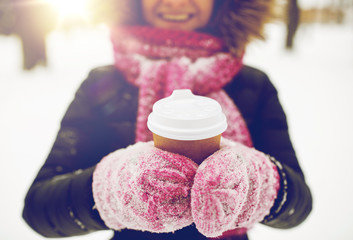 close up of hand with coffee outdoors in winter