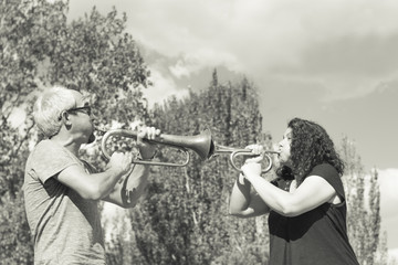 Man and woman playing trumpet © gemaibarra