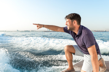 crew man is showing something at the sea