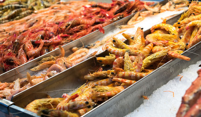 fresh shripms, prawns of differents sizes and types on ice in fish market, Tenerife. Spanish fish...