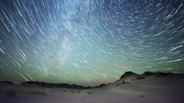 Milky Way comet like star trails over embryonic dunes timelapse