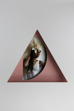 Studio shot of an African American woman behind geometrical shapes