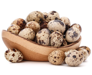 Obraz premium quail eggs in wooden bowl isolated on white background cutout