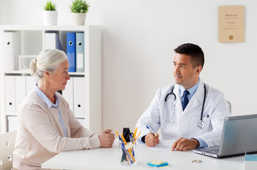 woman and doctor with prescription at clinic