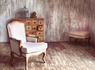 wooden chest of drawers in shabby styled room with bird cage and Mozart bust