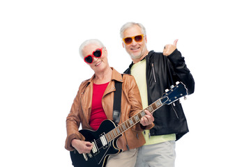 happy senior couple with guitar showing thumbs up