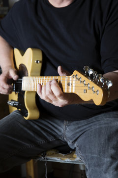 Man playing his telecaster guitar