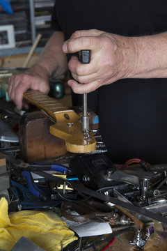 Guitar tuning machines being worked on in shop