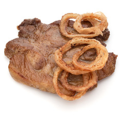 Cooked fried pork meat with onion slices garnish isolated on white background cutout