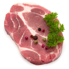 Raw pork neck chop meat with parsley herb leaves and peppercorn spices garnish isolated on white background cutout