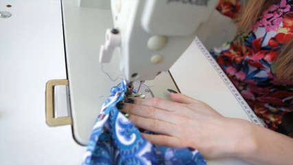 Obraz na płótnie Canvas Tailor.Hands notch tailor tailor's scissors cloth. Female tailor stitching material at workplace. Preparing fabric for clothes making. Tailoring, garment industry, designer workshop concept.