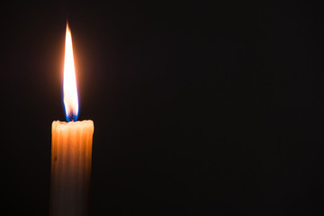single candle on a black candle