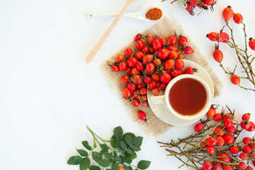 dog rose hips and herbal Tea on white background 