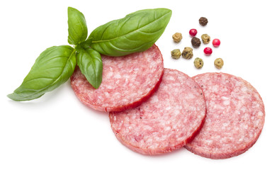 Salami smoked sausage three slices, basil leaves and peppercorns isolated on white background cutout