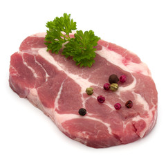 Raw pork neck chop meat with parsley herb leaves and peppercorn spices garnish isolated on white background cutout