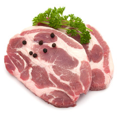 Raw pork neck chop meat with parsley herb leaves and peppercorn spices garnish isolated on white background cutout