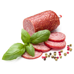 Salami smoked sausage, basil leaves and peppercorns isolated on white background cutout