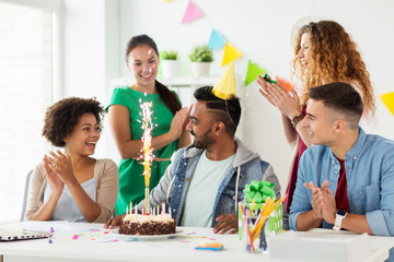 team greeting colleague at office birthday party
