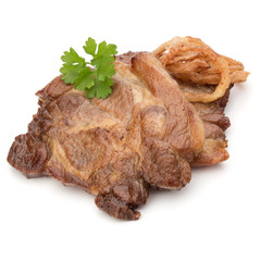 Cooked fried pork meat with parsley herb leaves and onion slices garnish isolated on white background cutout