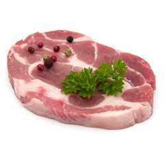 Raw pork neck chop meat with parsley herb leaves and peppercorn spices garnish isolated on white background cutout