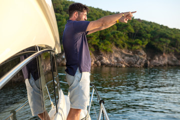Rich man waves somewhere at the sea