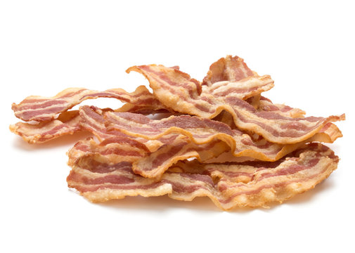 cooked crispy slices of bacon isolated on white background