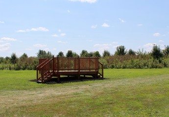 Obraz premium The wood deck in the grass field of the park.