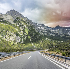 Highway outside the city receding into the highlands. Travel concept.