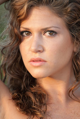 Brunette haired woman at the beach.