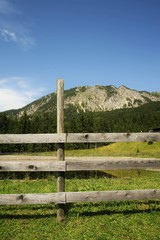 Wooden fence in the Alps under blue sky