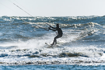 Kitesurfer riding ocean waves